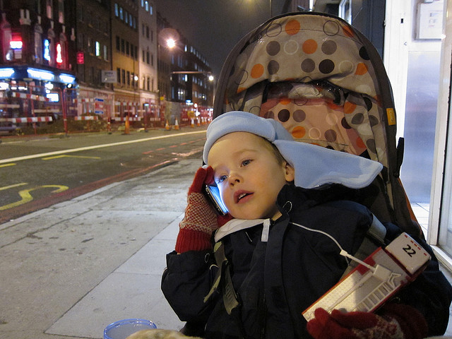 This pictuer shows a young child talking on the phone.