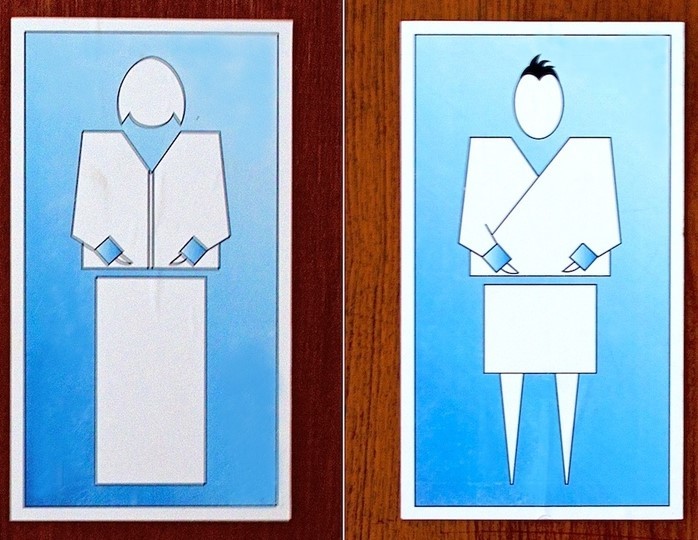 This picture shows restroom signs from the country of Bhutan, displaying stylized representations of a woman and man dressed in traditional clothing.
